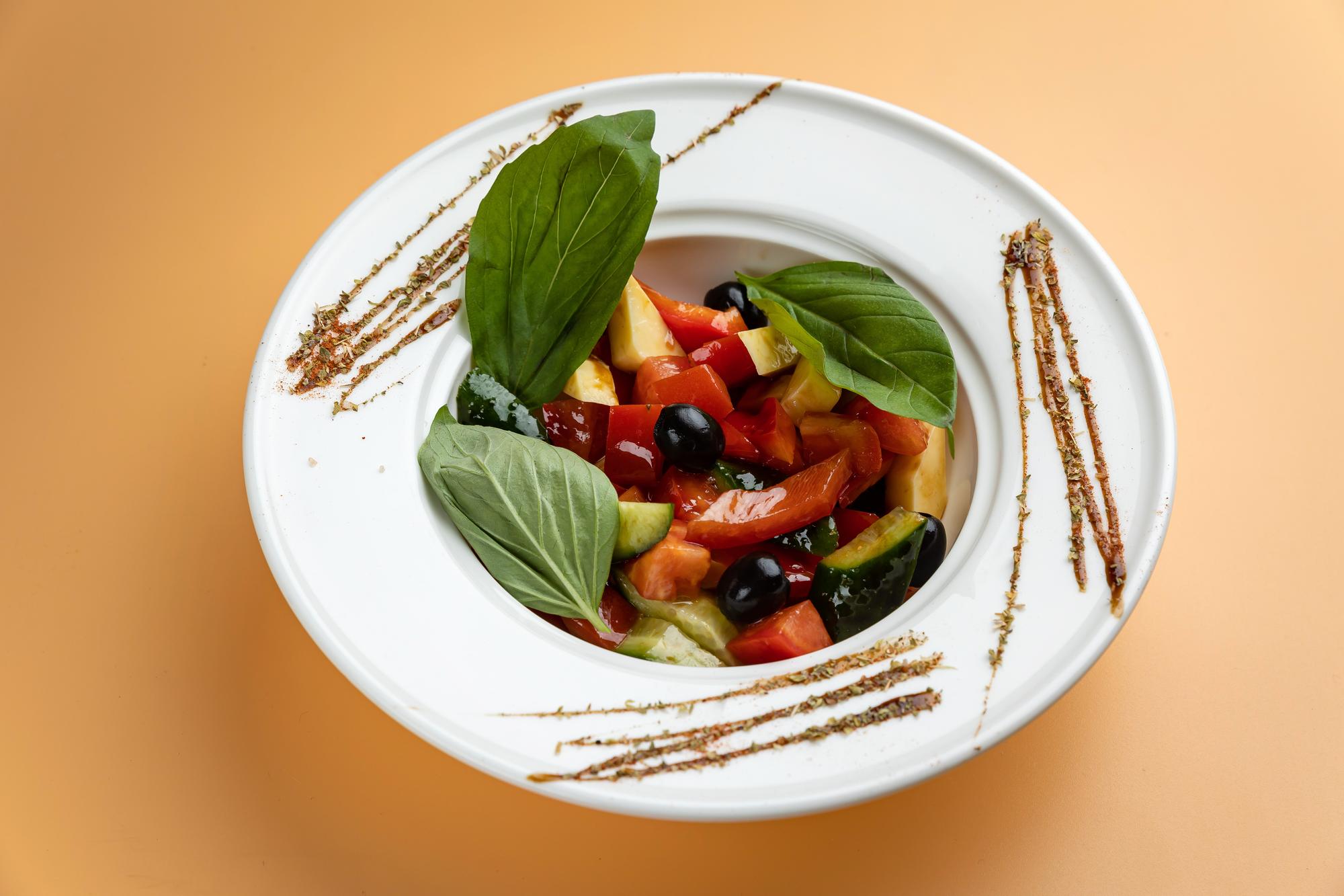 Close-up of plated seasonal salad on ceramic plate